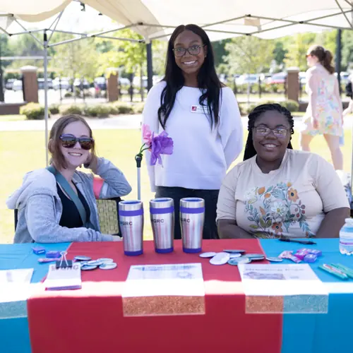 Student Assistants working a table at an event
